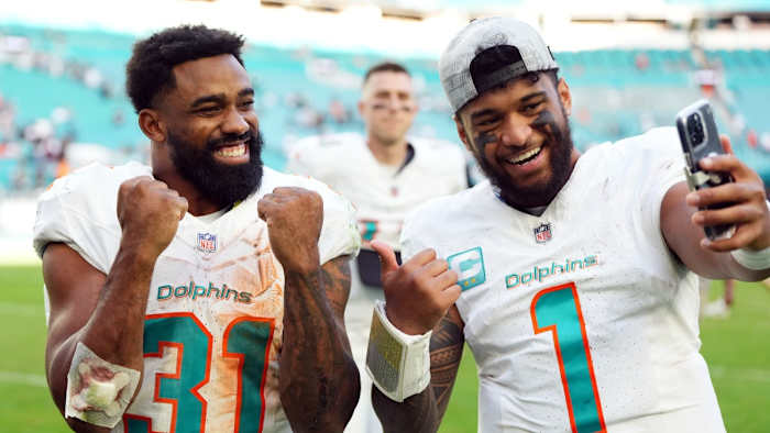 Dolphins running back Raheem Mostert (left) and quarterback Tua Tagovailoa.